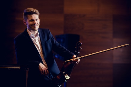 Jan Snakowski, musician, holding a viola in his hand